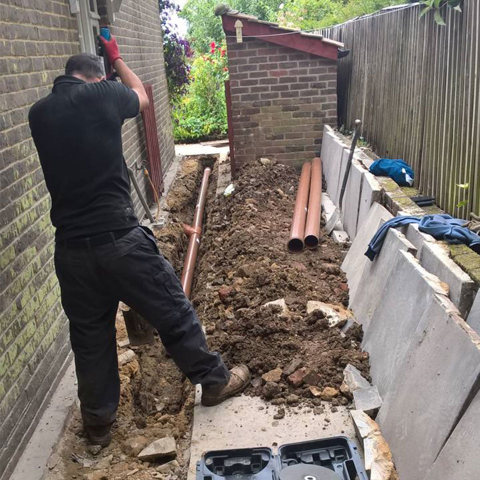 digging trench to re[air drain pipe